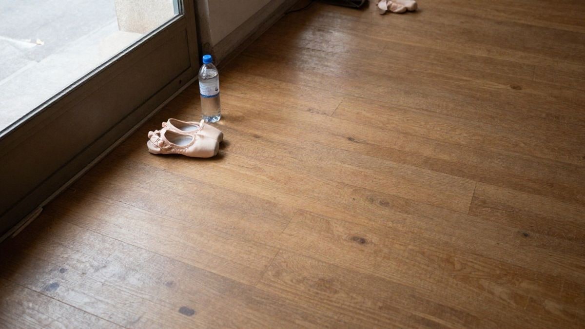 Illustrative image: aerial view of a dance room with shoes and a water bottle on the floor