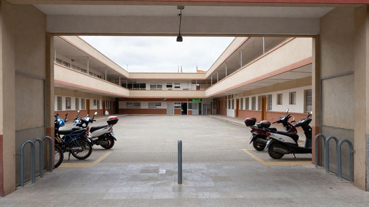 Illustrative image: generic school entrance with bicycles and scooters parked in the yard