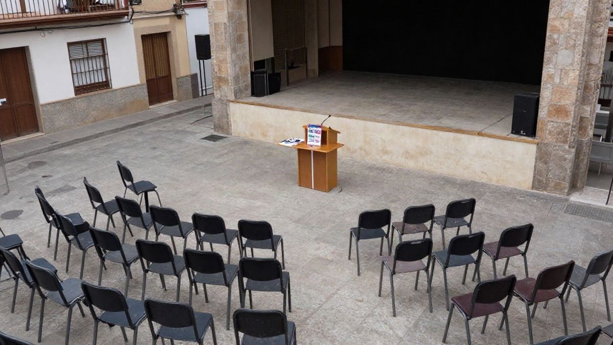 Illustrative image: aerial view of an auditorium with empty chairs and a small stage