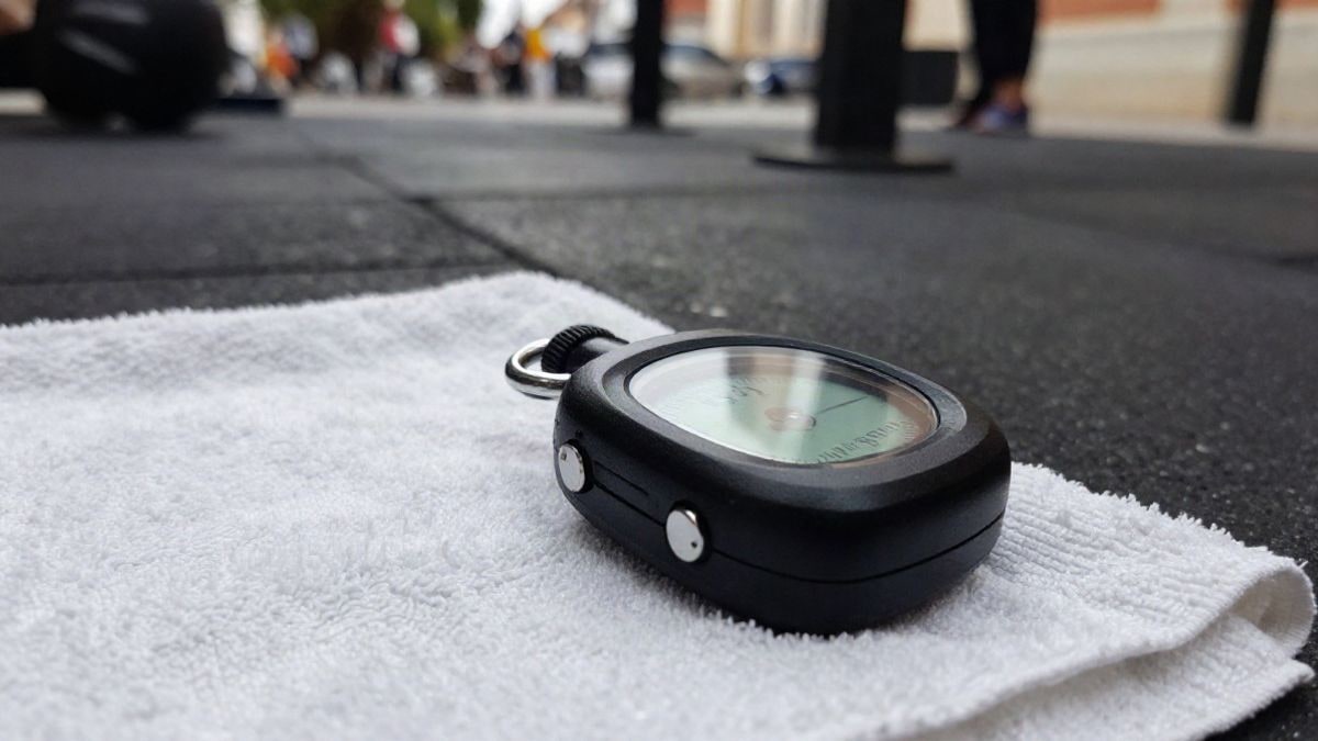 Illustrative image: stopwatch and towel on the floor of a gym