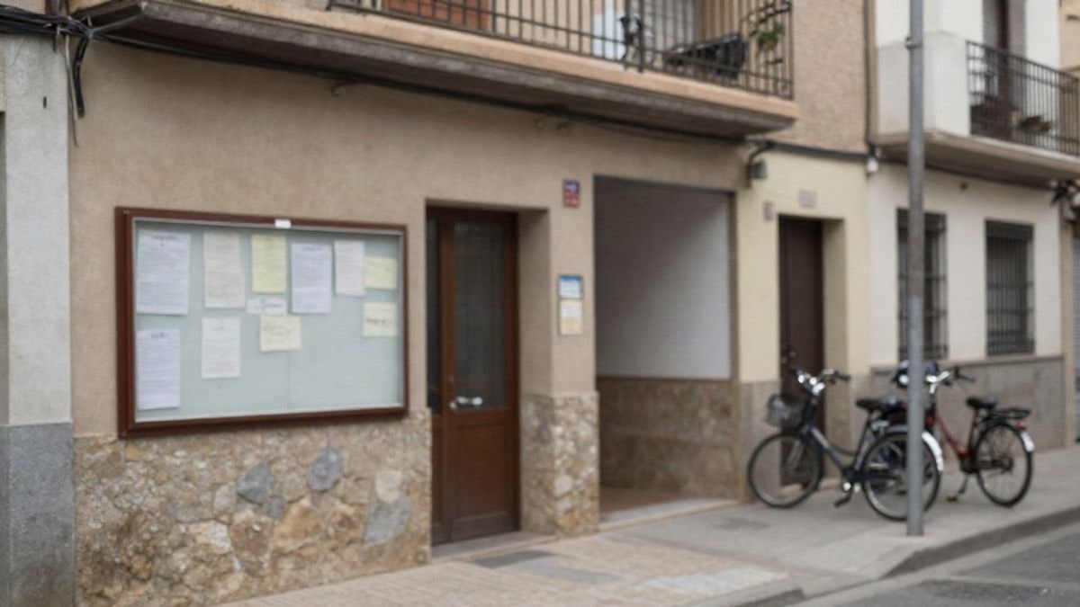 Illustrative image: entrance of a community centre with a notice board and bicycles parked on a residential street